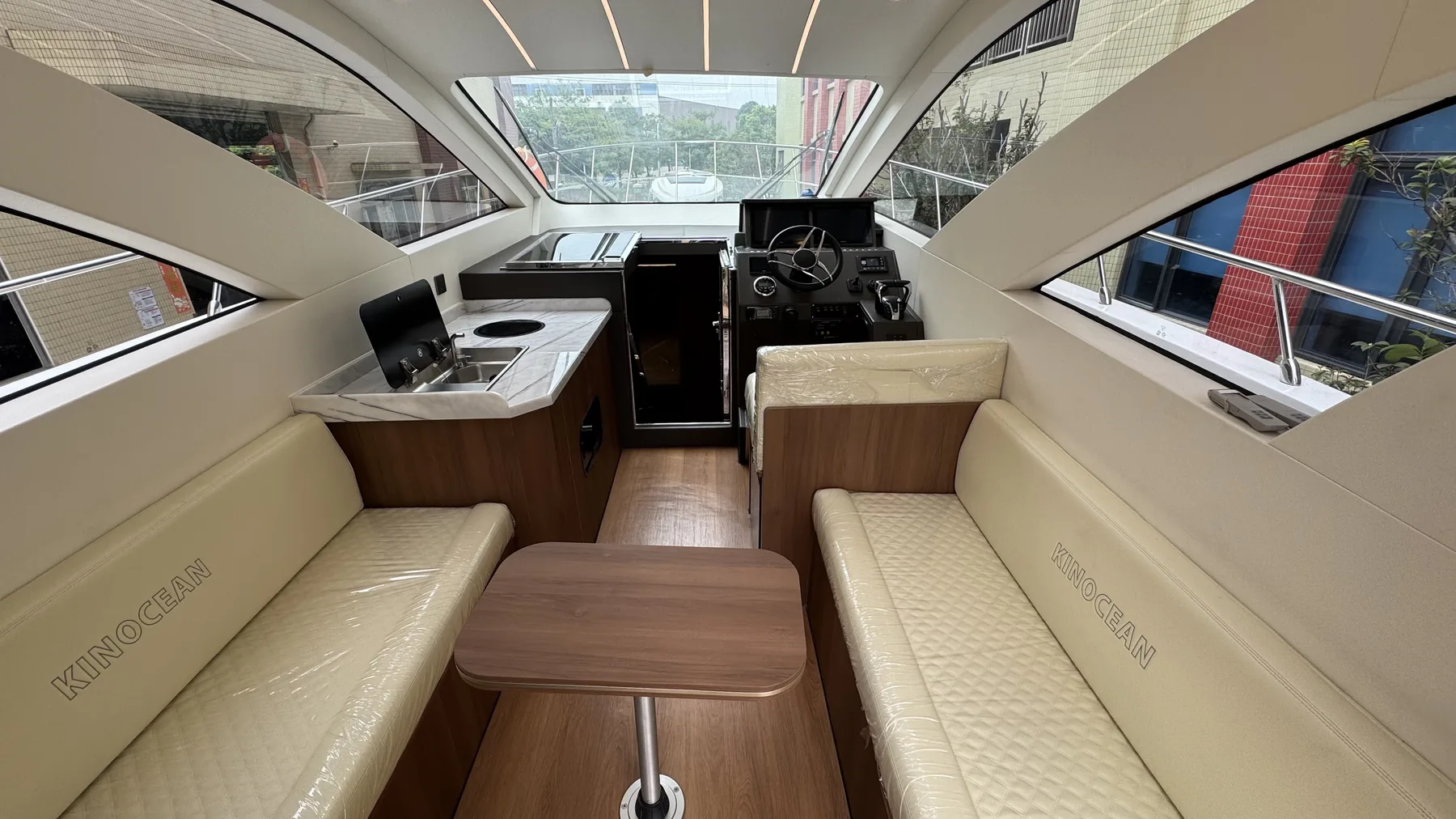 SY-410 main salon with helm, galley and facing sofas